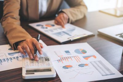 A real estate agent reviews hard copies of reports.